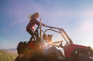 Image showing group of young people having fun while driving a off road buggy 