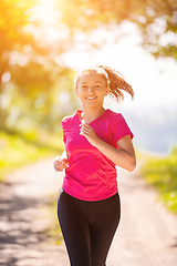 Image showing young woman jogging on sunny day at nature