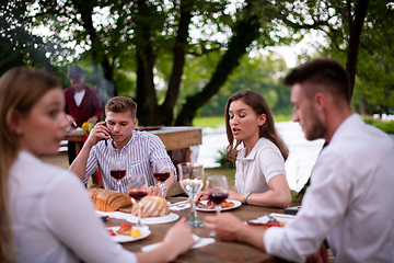 Image showing happy friends having picnic french dinner party outdoor