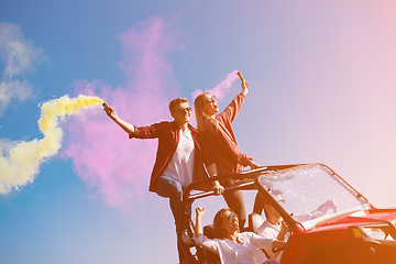 Image showing group of young people having fun while driving a off road buggy 