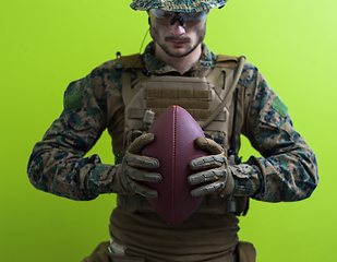 Image showing solder holding american football ball