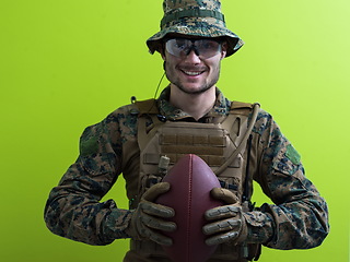 Image showing solder holding american football ball