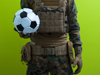 Image showing solder holding soccer  ball