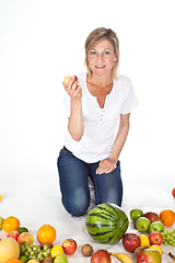 Image showing Blond cute woman eating an apple