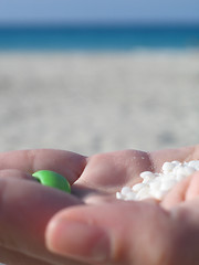 Image showing white tiny shell in the palm of a hand