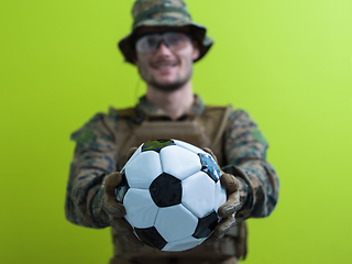 Image showing solder holding soccer  ball