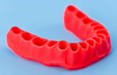 Image showing model of human gums without teeth isolated on blue
