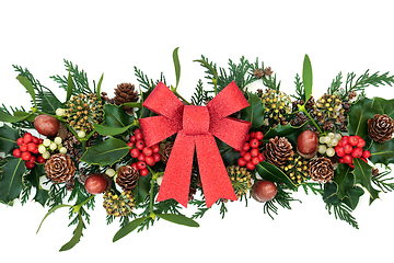Image showing Red Glitter Bow with Holly and Natural Winter Greenery