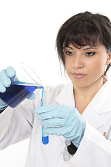 Image showing Chemist pours liquid into test tube