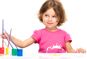 Image showing Little girl is painting with gouache