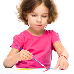 Image showing Little girl is painting with gouache