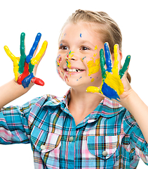 Image showing Portrait of a cute girl playing with paints