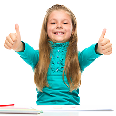 Image showing Little girl is showing thumb up sign