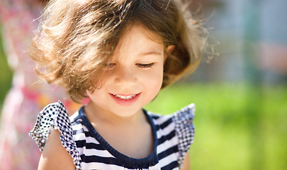 Image showing Cute little girl is playing in playground