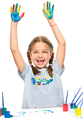 Image showing Portrait of a cute girl playing with paints