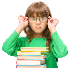 Image showing Little girl is reading a book