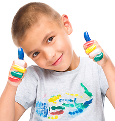 Image showing Portrait of a cute boy playing with paints