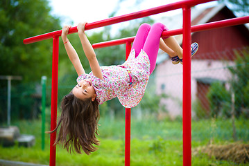 Image showing Cute little girl is playing in playground