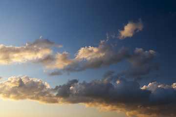 Image showing clouds of white and gray in the sunlight close-up