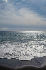 Image showing ocean water on black sand