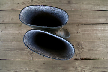 Image showing Rubber boots on the wooden floor. 