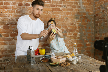 Image showing Young couple cooking and recording live video for vlog and social media