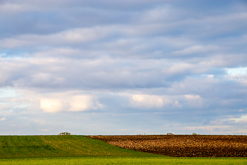 Image showing Landscape with plowed field and blue sky.