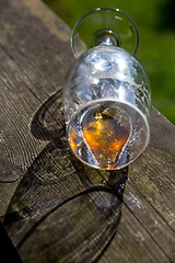 Image showing Overturned glass of beer on wooden table.