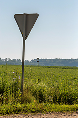 Image showing Road sign next to the rural road.