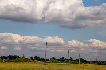 Image showing Landscape with cereal field, trees and cloudy blue sky