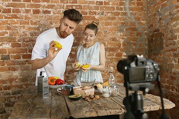 Image showing Young couple cooking and recording live video for vlog and social media