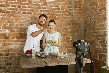 Image showing Young couple cooking and recording live video for vlog and social media