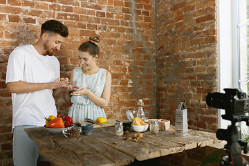 Image showing Young couple cooking and recording live video for vlog and social media