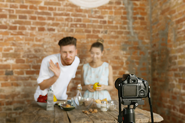 Image showing Young couple cooking and recording live video for vlog and social media