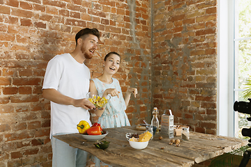 Image showing Young couple cooking and recording live video for vlog and social media