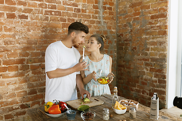 Image showing Young couple cooking and recording live video for vlog and social media