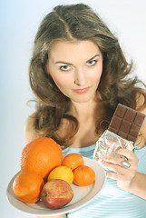 Image showing A woman with fruits and chocolate