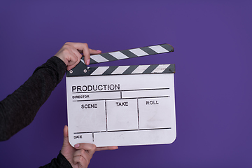 Image showing movie clapper on purple background