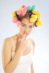 Image showing A woman in hair curlers