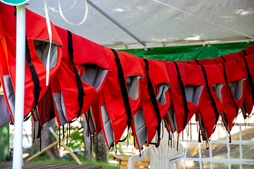 Image showing Life jackets drying in the shed.