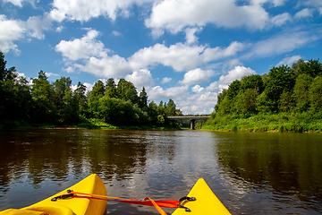 Image showing Yellow boat ride by the river.