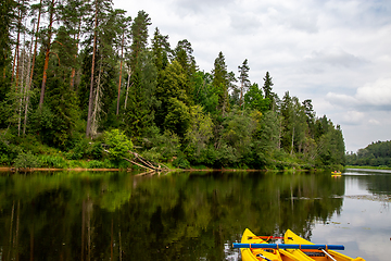 Image showing Yellow boat ride by the river.