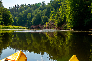 Image showing Yellow boat ride by the river.