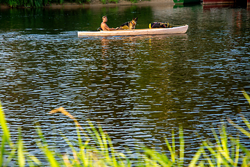 Image showing Boat trip by boat on the river with dog.