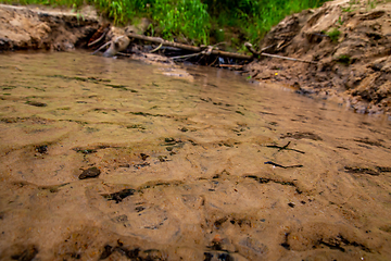 Image showing Reflections in shallow river as background.