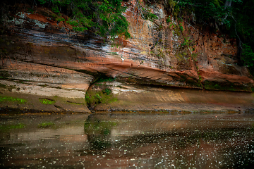 Image showing Red sandstone cliff near the river.