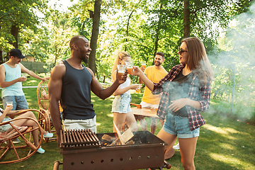 Image showing Happy friends are having beer and barbecue party at sunny day