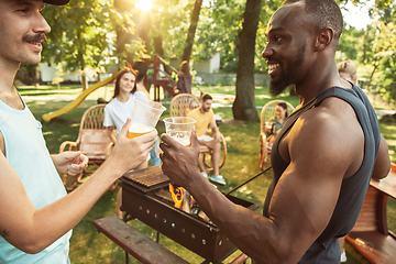 Image showing Happy friends are having beer and barbecue party at sunny day