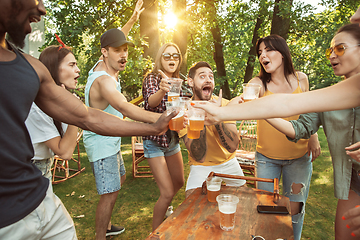 Image showing Happy friends are having beer and barbecue party at sunny day