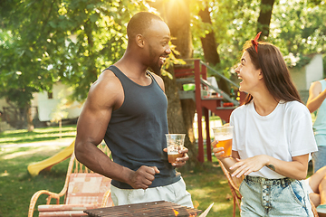 Image showing Happy friends are having beer and barbecue party at sunny day